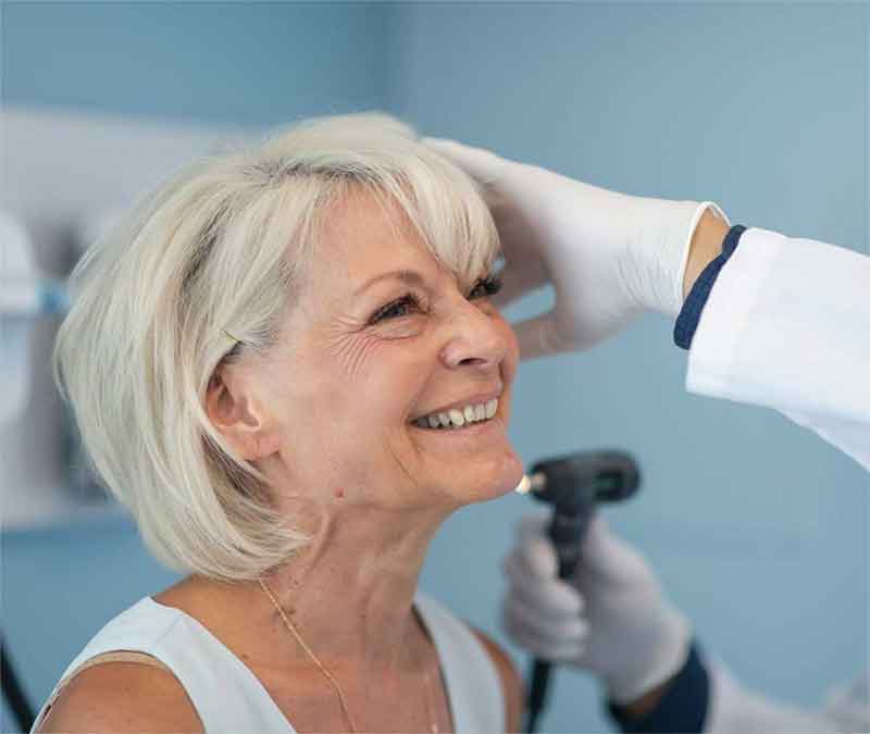 Woman having her hearing tested to check for hearing loss.