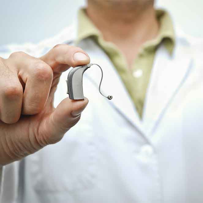 Man holding a hearing aid