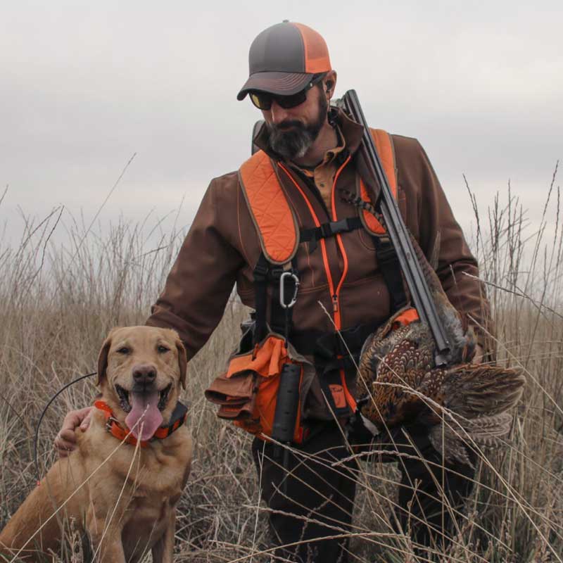 A hunter with his dog using SoundGear hearing protection.